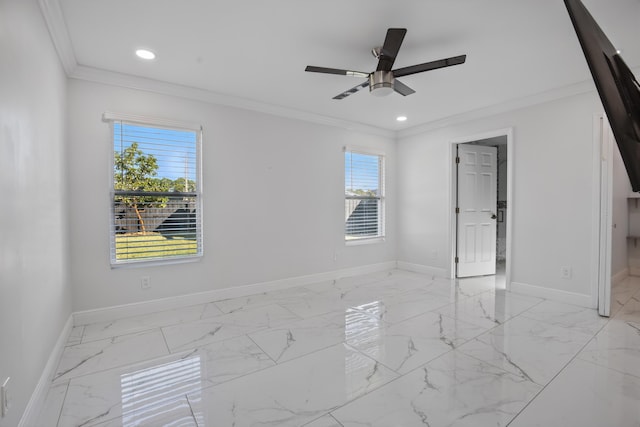 empty room featuring a healthy amount of sunlight, marble finish floor, baseboards, and crown molding