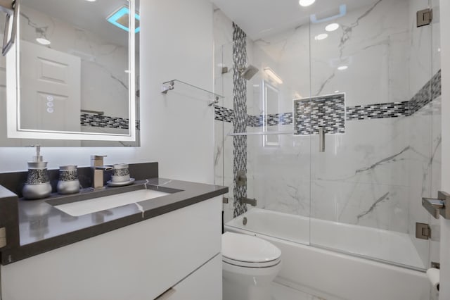 bathroom featuring marble finish floor, combined bath / shower with glass door, vanity, and toilet