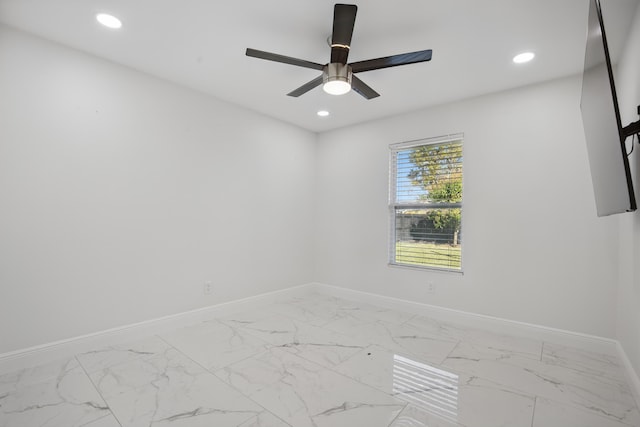 empty room with recessed lighting, marble finish floor, ceiling fan, and baseboards