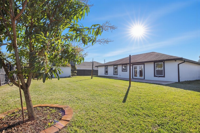 view of yard with french doors and a fenced backyard