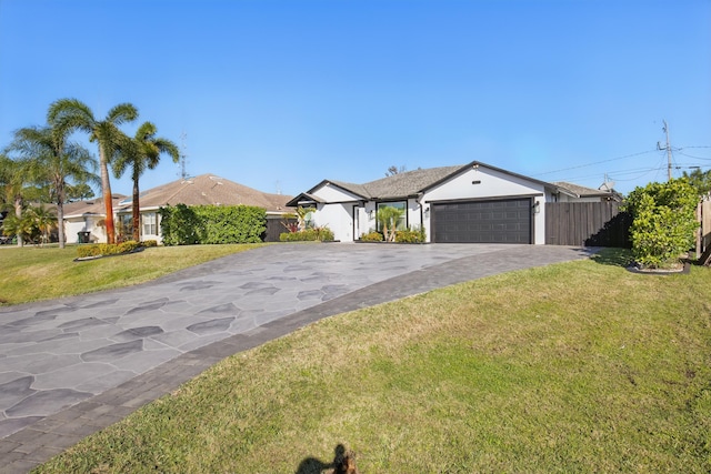 ranch-style home with aphalt driveway, a front lawn, an attached garage, and fence