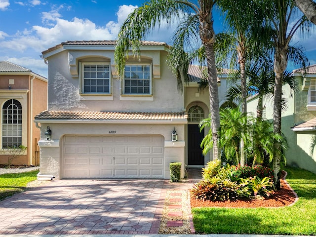 mediterranean / spanish-style home featuring a garage