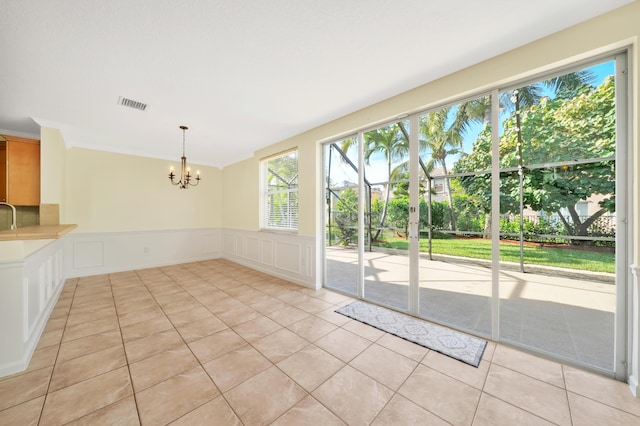 interior space with sink, light tile patterned floors, and a chandelier