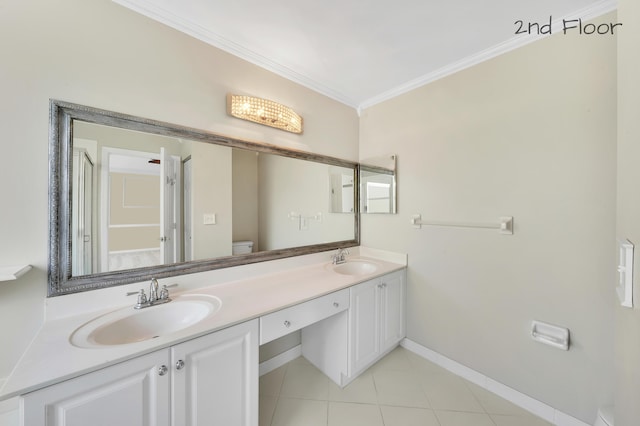 bathroom with tile patterned flooring, vanity, toilet, and crown molding