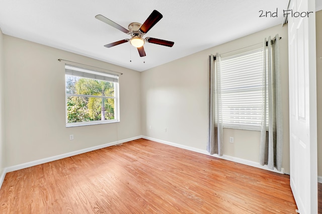 empty room featuring ceiling fan and light wood-type flooring