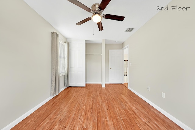 unfurnished bedroom with a closet, light hardwood / wood-style floors, and ceiling fan