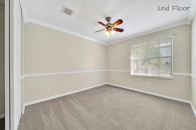 carpeted empty room featuring a textured ceiling, ceiling fan, and crown molding