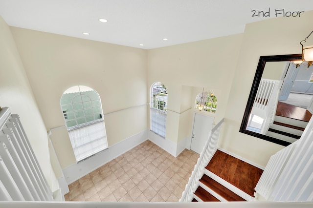 entrance foyer featuring a chandelier and a towering ceiling