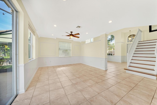 empty room featuring ceiling fan and light tile patterned flooring