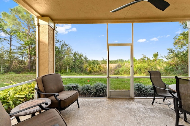 sunroom / solarium featuring ceiling fan