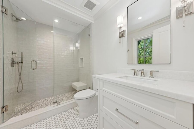 bathroom featuring tile patterned floors, vanity, crown molding, toilet, and a shower with shower door