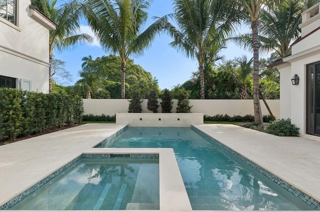 view of swimming pool with an in ground hot tub