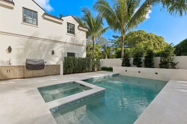 view of pool featuring area for grilling, an in ground hot tub, and sink