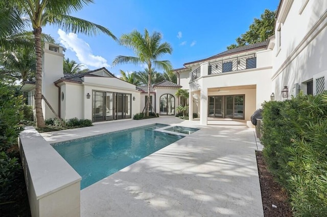 rear view of property with a patio area and a balcony