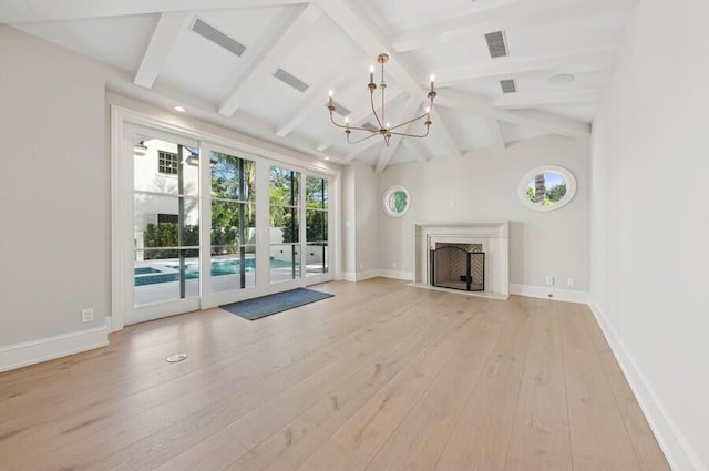 unfurnished living room featuring vaulted ceiling with beams, a notable chandelier, and light hardwood / wood-style flooring