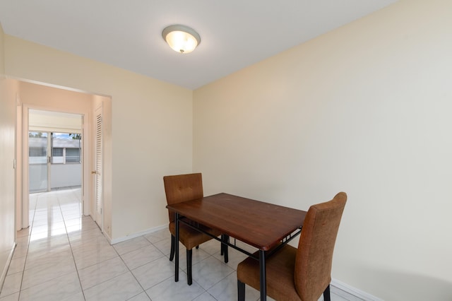 dining space featuring light tile patterned flooring