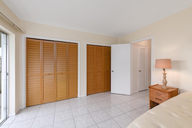 tiled bedroom with multiple closets