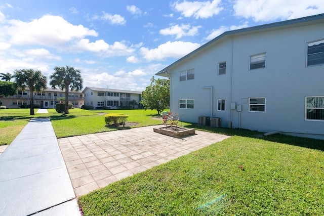 view of yard featuring a patio and central AC