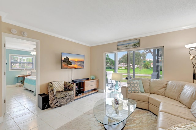 living room with ceiling fan, a wealth of natural light, light tile patterned floors, and ornamental molding