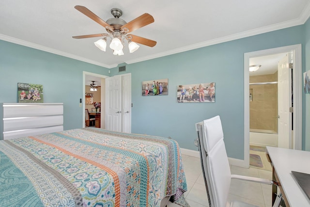 tiled bedroom with ceiling fan, ornamental molding, and ensuite bath