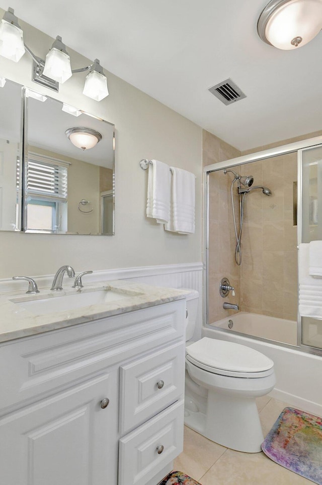 full bathroom with toilet, tile patterned flooring, vanity, and combined bath / shower with glass door