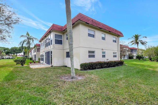 view of side of property with a lawn