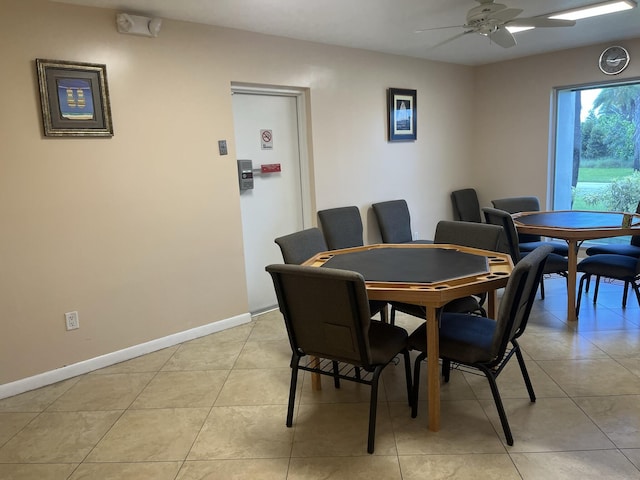 tiled dining area with ceiling fan