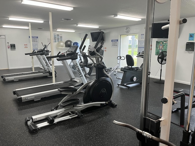 gym featuring a textured ceiling