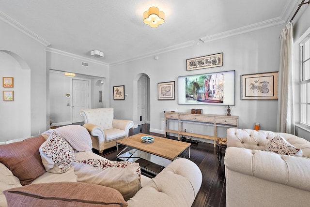 living room with a healthy amount of sunlight, dark hardwood / wood-style floors, and ornamental molding