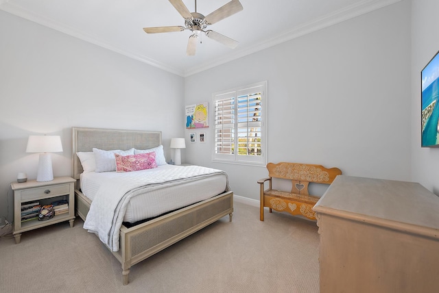 carpeted bedroom featuring ceiling fan and crown molding