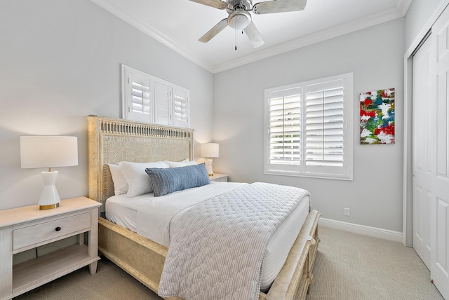 carpeted bedroom with a closet, crown molding, and ceiling fan