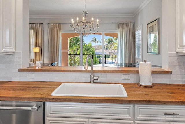 kitchen with white cabinets, decorative backsplash, and sink