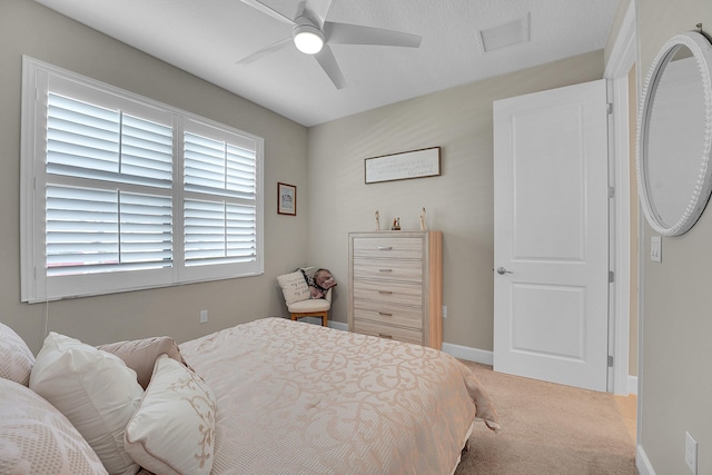 bedroom featuring ceiling fan and carpet