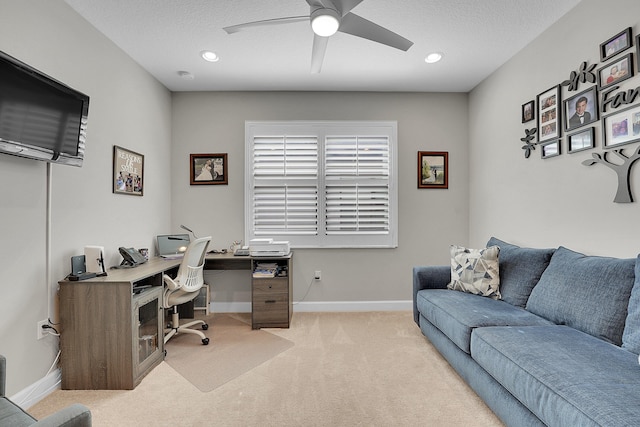 office area with light carpet, a textured ceiling, and ceiling fan