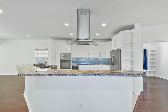 kitchen with white cabinetry, a large island with sink, island range hood, and stainless steel appliances