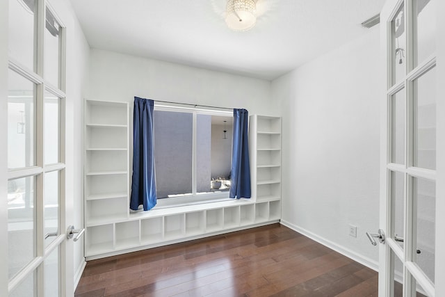 empty room with dark hardwood / wood-style floors