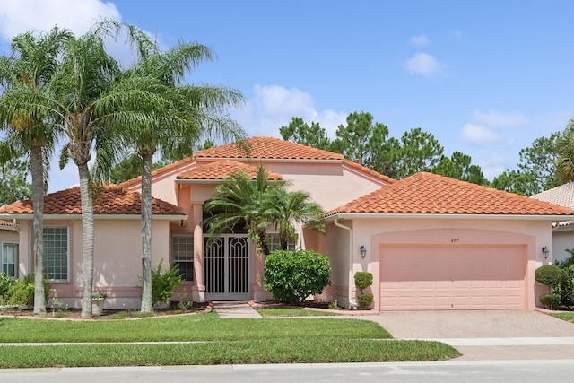 mediterranean / spanish-style home with a garage