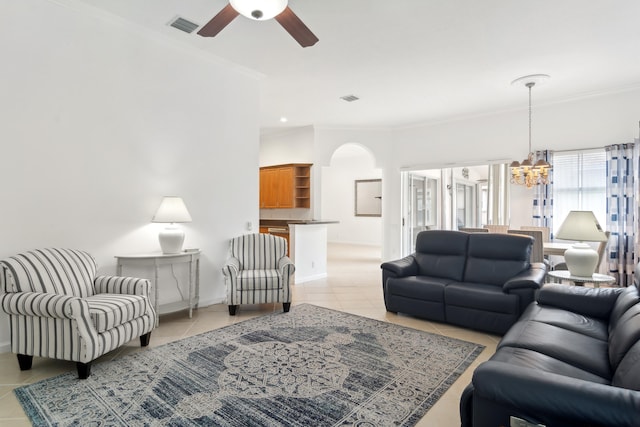 tiled living room featuring ceiling fan with notable chandelier and crown molding