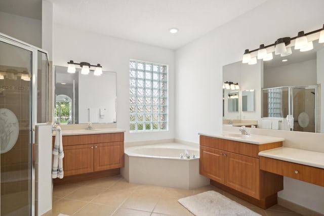 bathroom featuring tile patterned floors, plenty of natural light, vanity, and independent shower and bath