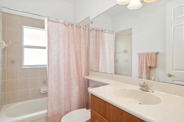 full bathroom featuring shower / bath combo with shower curtain, vanity, and toilet