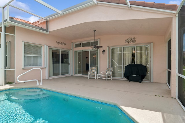 view of swimming pool with a patio, ceiling fan, and a lanai