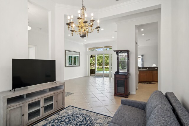 living room featuring light tile patterned floors, crown molding, and a chandelier