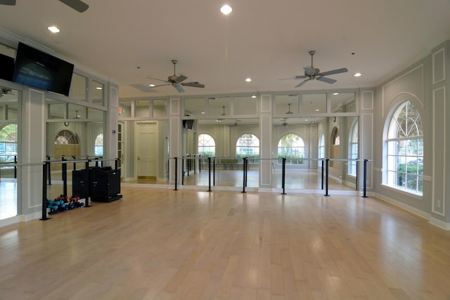 interior space featuring ceiling fan, light hardwood / wood-style floors, and crown molding