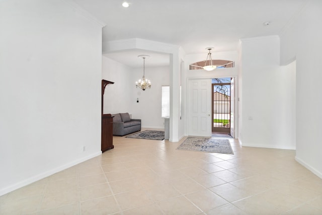 entryway featuring ornamental molding, a notable chandelier, and light tile patterned flooring