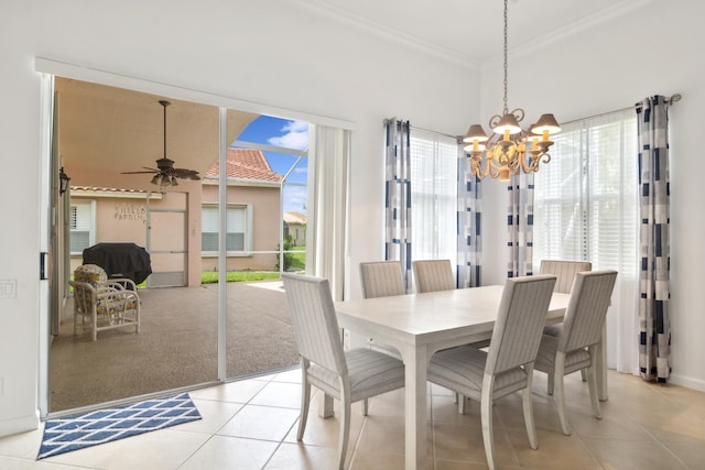 tiled dining area featuring ceiling fan with notable chandelier and ornamental molding