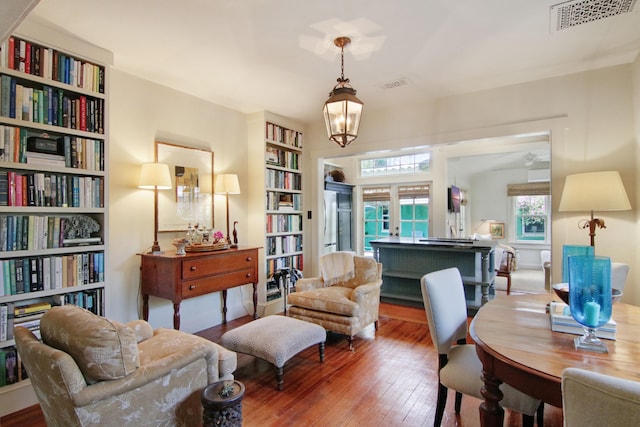 sitting room with hardwood / wood-style floors, a notable chandelier, and french doors