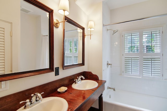 bathroom with washtub / shower combination and vanity