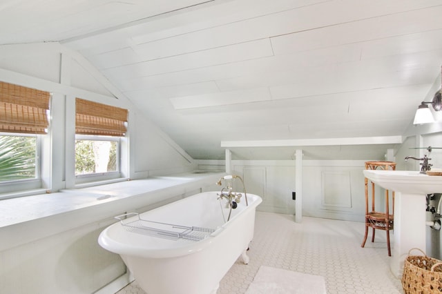 bathroom with a tub and vaulted ceiling