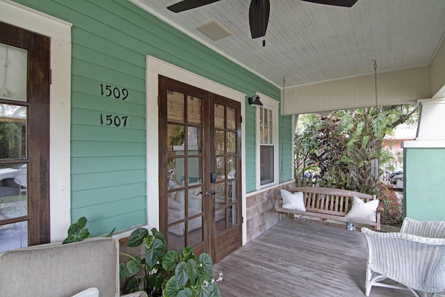 deck featuring ceiling fan, french doors, and covered porch