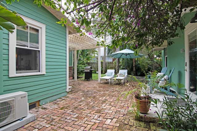 view of patio / terrace with ac unit, a pergola, and area for grilling